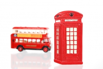 a red double-decker London bus and a red UK telephone call box