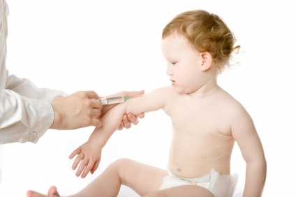 a toddler receiving a shot in its right arm