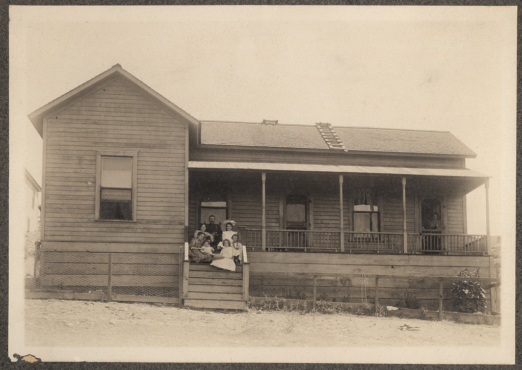 family on steps of home