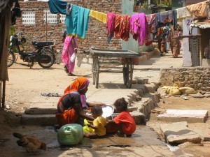 dscf0540 A women washing clothes in one of the slums that we visited in Udaipur.