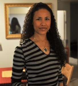 head and torso portrait of elesia ashkenazy, a multiracial woman with long curly black hair