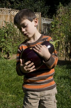 Kid with eggplant