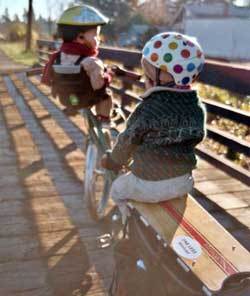 Sarah Gilbert\'s custom stretch bicycle, with two of her three sons on board.