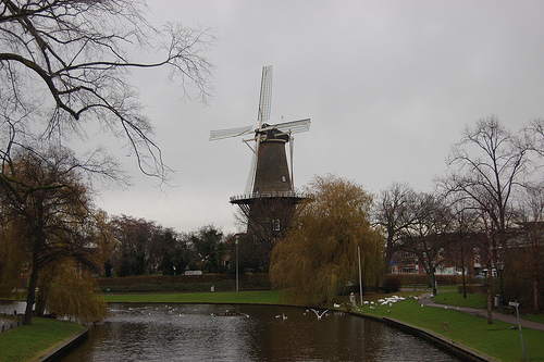 plains with a waterway in foreground and windmill in background