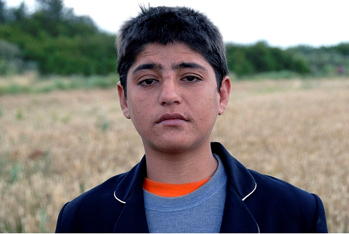 An Afghan boy, who says he travelled to France from Afghanistan overland, is among the hundred of people living at a makeshift settlement near the city of Dunkerque. UNHCR / H. J. Davies / July 2009