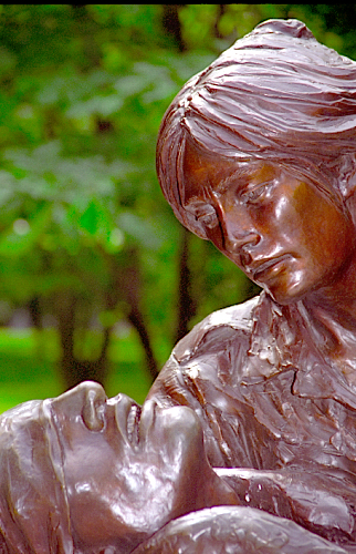 Vietnam Women's Memorial, bronze statue of a woman holding a wounded souldier as she tends his wounds