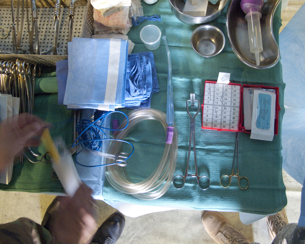 a medical tray set up with a variety of surgical instruments.