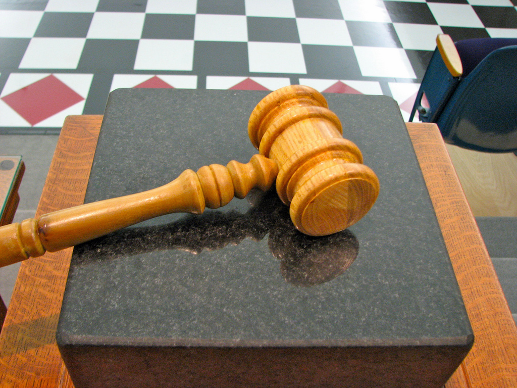 a wooden gavel sits on a marble slab