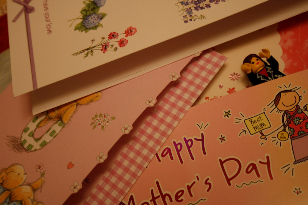 A pile of pink cards for mother's day, and a tiny woman made out of lego pieces.
